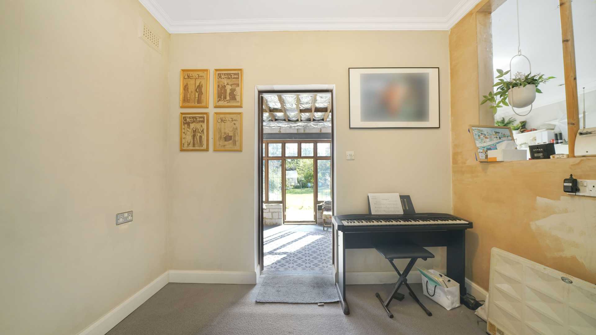 Double bedroom with white bedding, bedside table and framed wall art